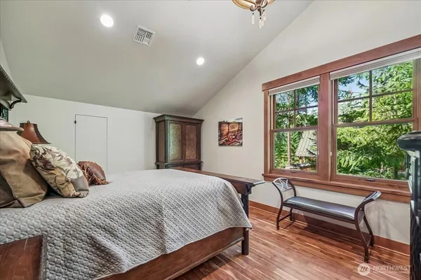 a bedroom with a bed and a large window