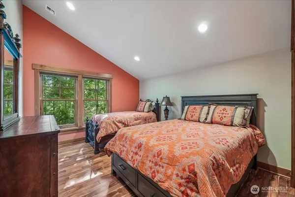a bedroom with two beds and a large window