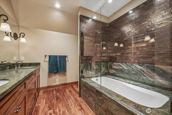 a bathroom with a granite countertop sink toilet and shower