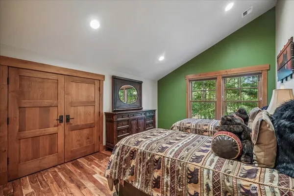 a bedroom with a bed dresser and a window