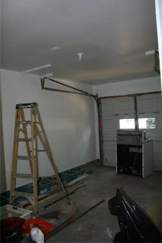 a room with exposed pipes and a window