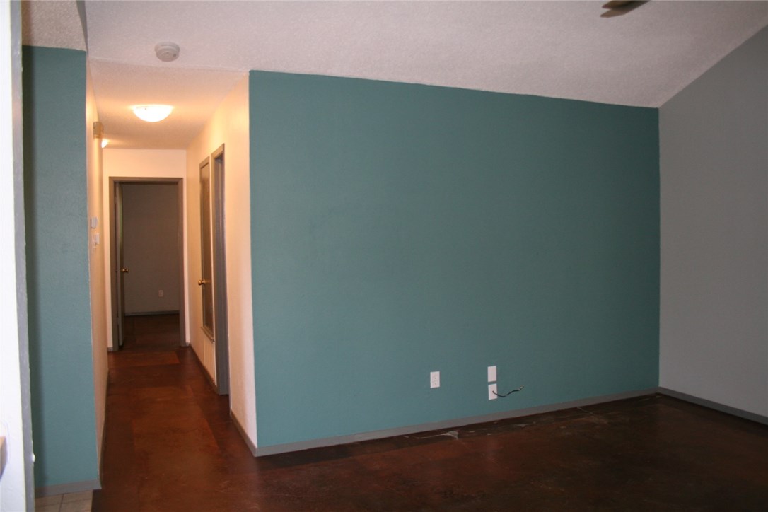 103 Cloudview Drive, Unit A Austin, TX 78745 - Photo 6 of 17 an empty room with wooden floor and windows