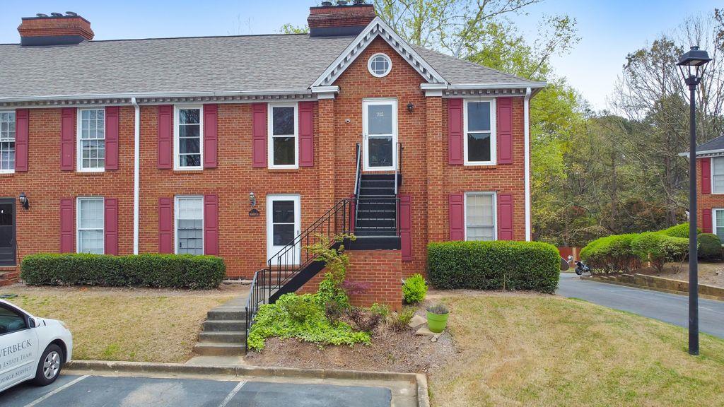 1166 Booth Road Southwest, Unit 212 Marietta, GA 30008 - Photo 1 of 1 a front view of a house with garden