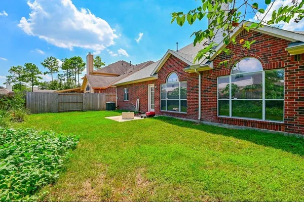 a view of a house with a yard and potted plants