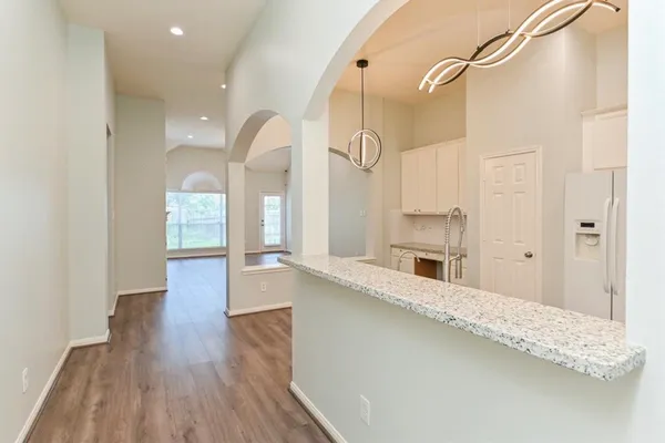 a large white kitchen with a large window