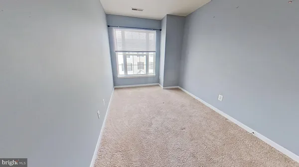 a view of a big room with closet and wooden floor