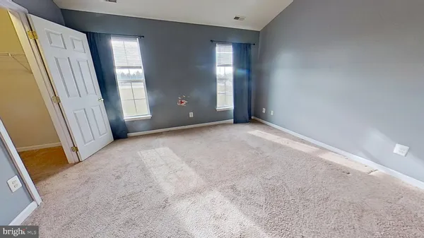 a view of a room with staircase and mirror