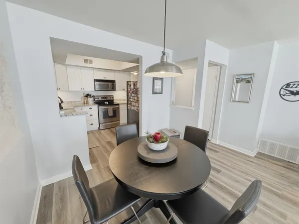 a view of a dining room with furniture wooden floor and chandelier