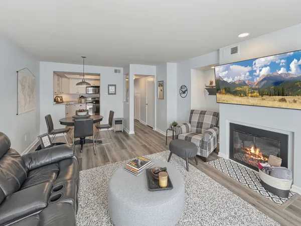 a living room with furniture and a fireplace