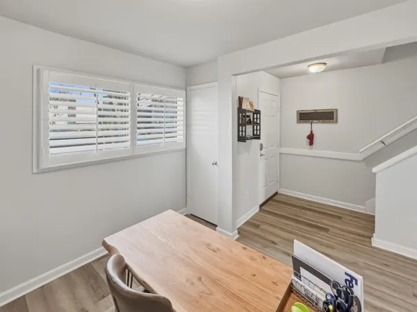 a view of a room with wooden floor and white walls