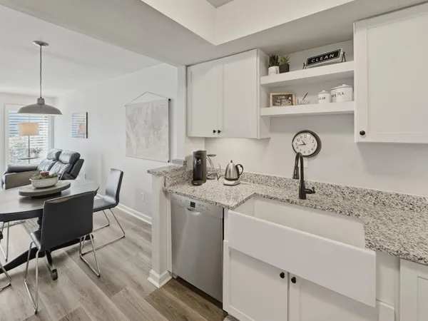 a kitchen with a sink cabinets and wooden floor