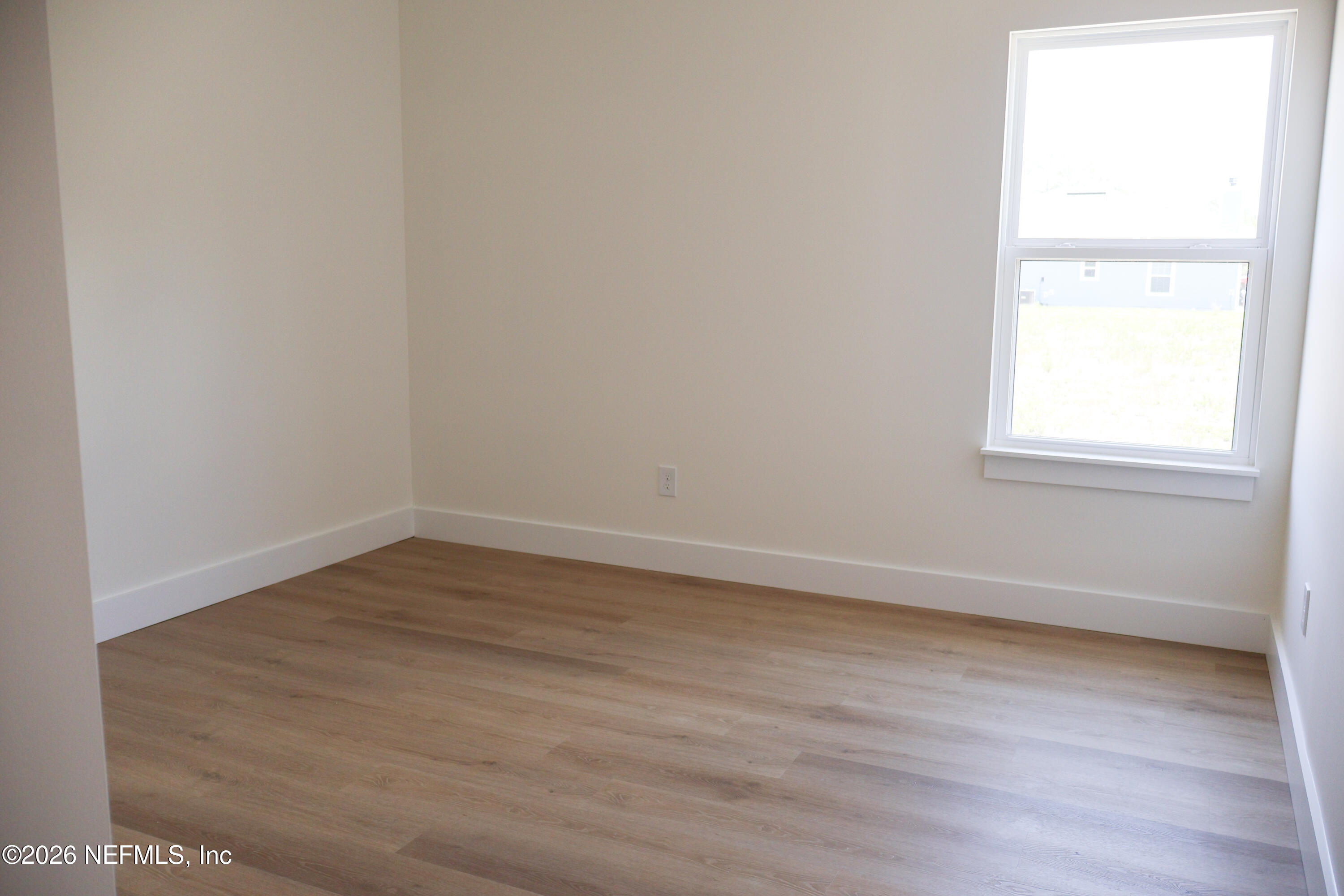 261121 Rowe Road Hilliard, FL 32046 - Photo 22 of 33 an empty room with wooden floor and windows