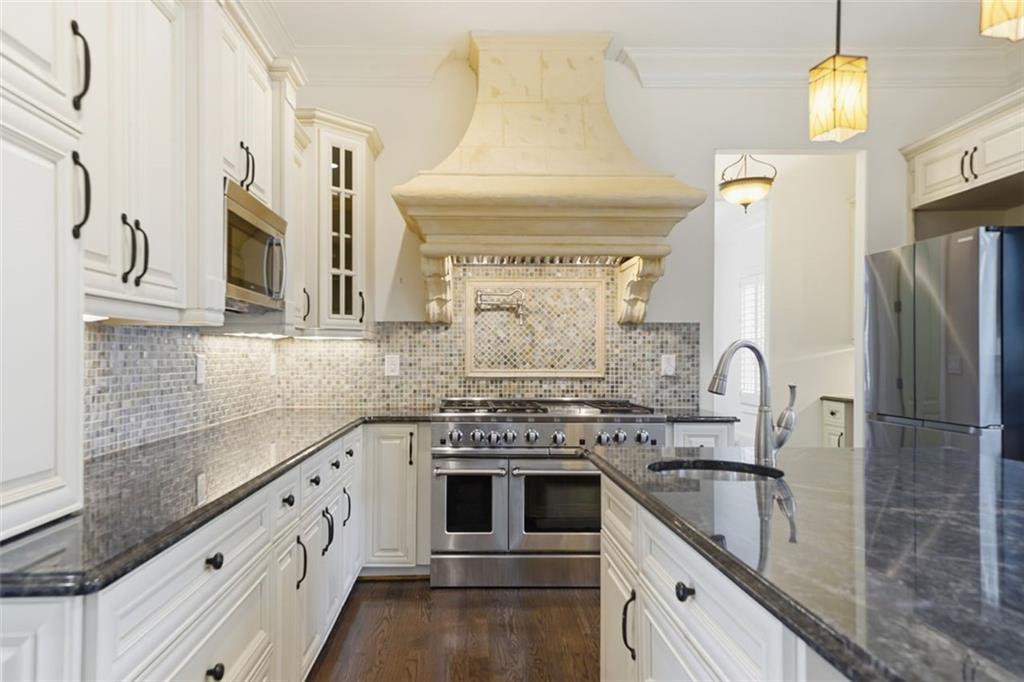7611 Regency Circle Sandy Springs, GA 30350 - Photo 12 of 74 a kitchen with stainless steel appliances granite countertop a sink stove and refrigerator