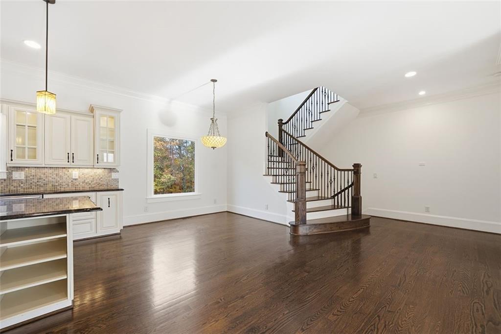 7611 Regency Circle Sandy Springs, GA 30350 - Photo 14 of 74 a view of an empty room with a window and wooden floor