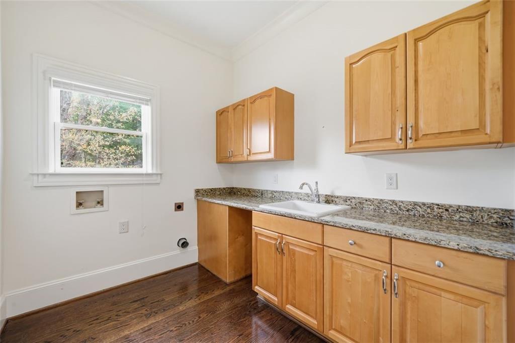 7611 Regency Circle Sandy Springs, GA 30350 - Photo 17 of 74 a kitchen with granite countertop cabinets sink and wooden floor