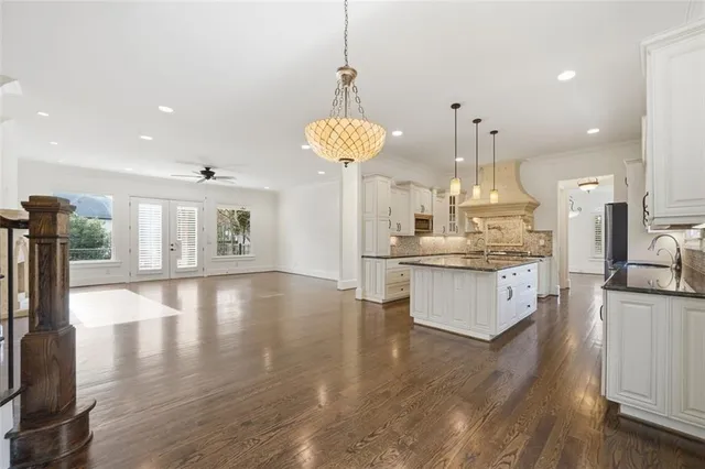 a bathroom with a granite countertop sink a toilet and a mirror