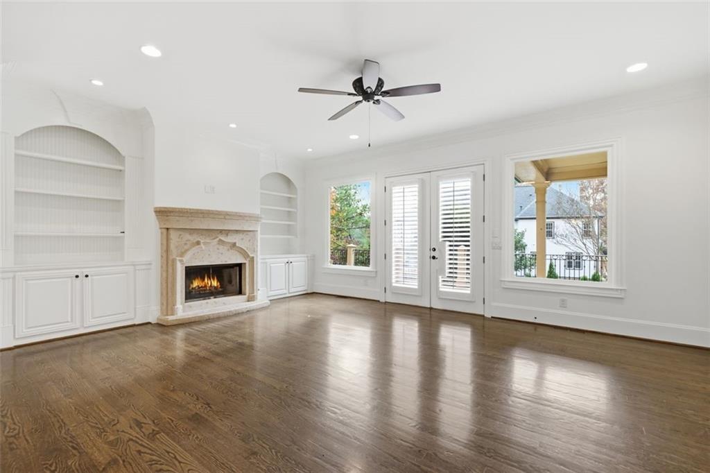 7611 Regency Circle Sandy Springs, GA 30350 - Photo 21 of 74 wooden floor fireplace and windows in an empty room
