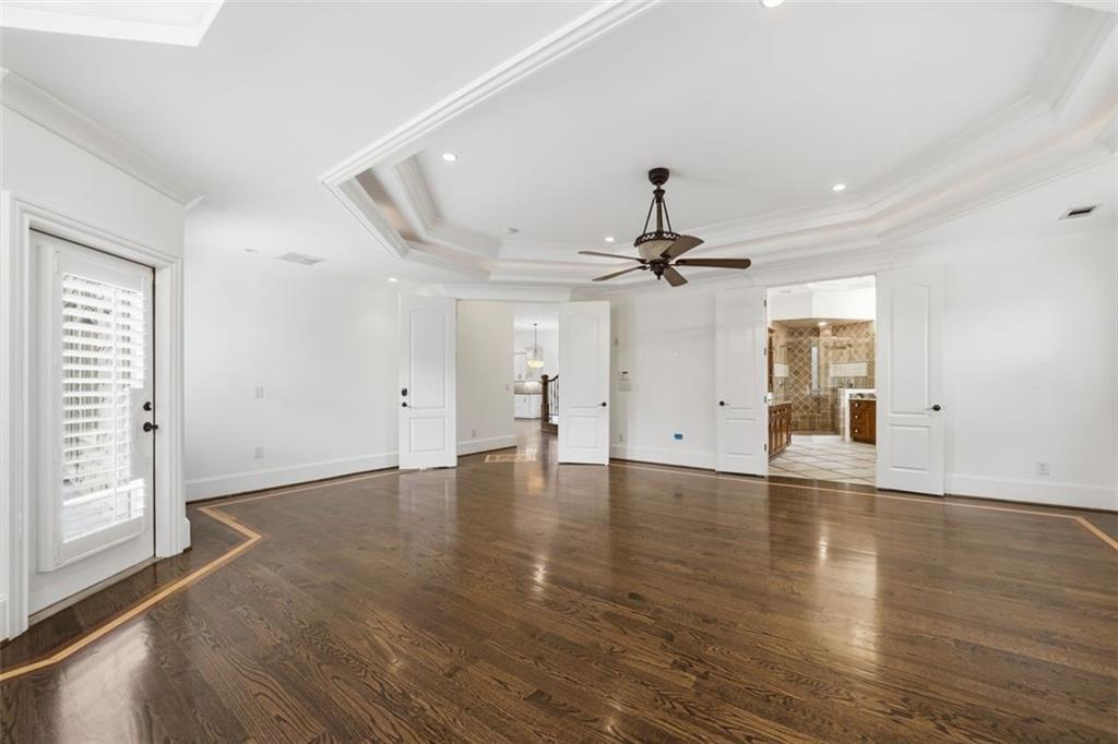 7611 Regency Circle Sandy Springs, GA 30350 - Photo 26 of 74 an empty room with wooden floor ceiling fan and windows