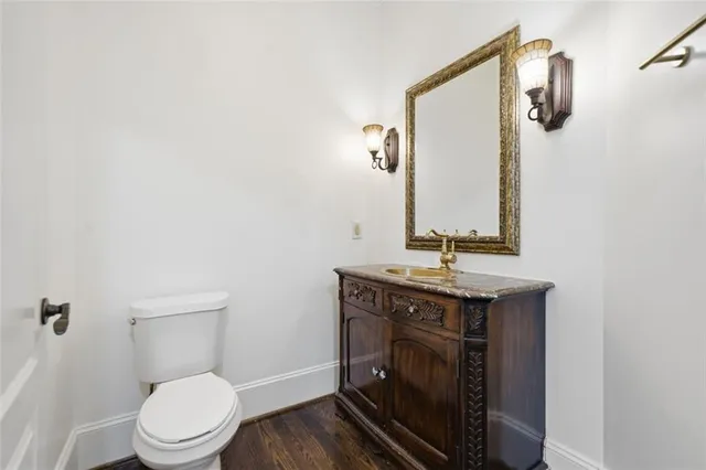 a bathroom with a granite countertop sink a toilet a bathtub and shower