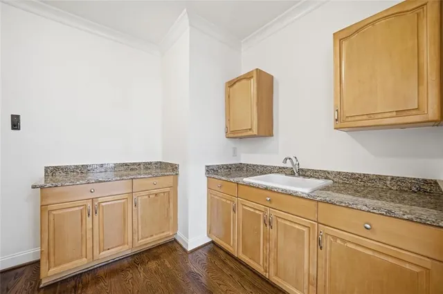 a view of an empty room with a kitchen