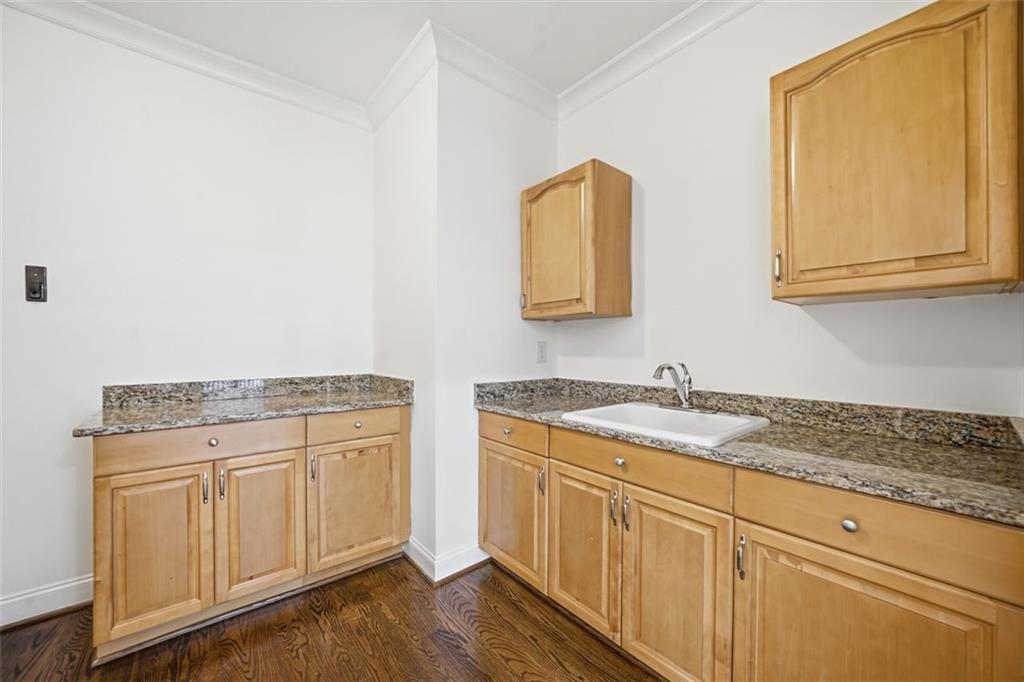 7611 Regency Circle Sandy Springs, GA 30350 - Photo 45 of 74 a bathroom with a granite countertop sink and a mirror