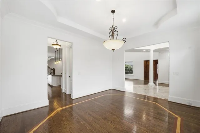 a kitchen with stainless steel appliances granite countertop a sink a stove and a wooden floor