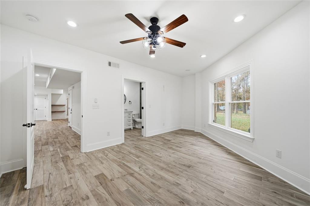 7611 Regency Circle Sandy Springs, GA 30350 - Photo 51 of 74 a view of an empty room with wooden floor and a window