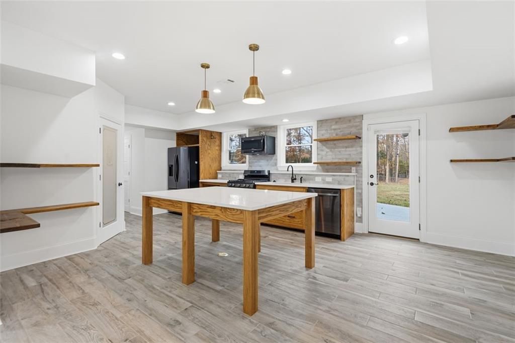 7611 Regency Circle Sandy Springs, GA 30350 - Photo 58 of 74 a kitchen with stainless steel appliances granite countertop a sink and a refrigerator
