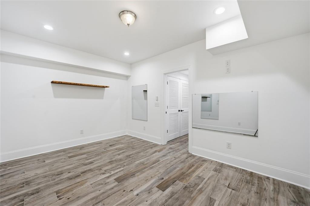 7611 Regency Circle Sandy Springs, GA 30350 - Photo 63 of 74 an empty room with wooden floor and windows