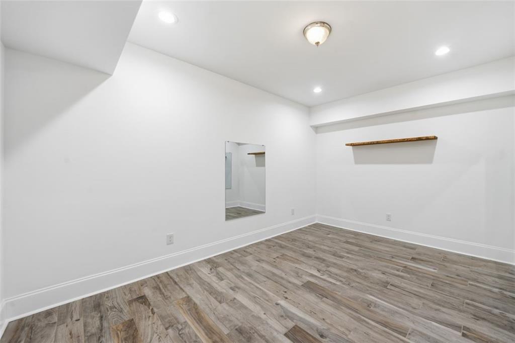 7611 Regency Circle Sandy Springs, GA 30350 - Photo 64 of 74 an empty room with wooden floor and windows
