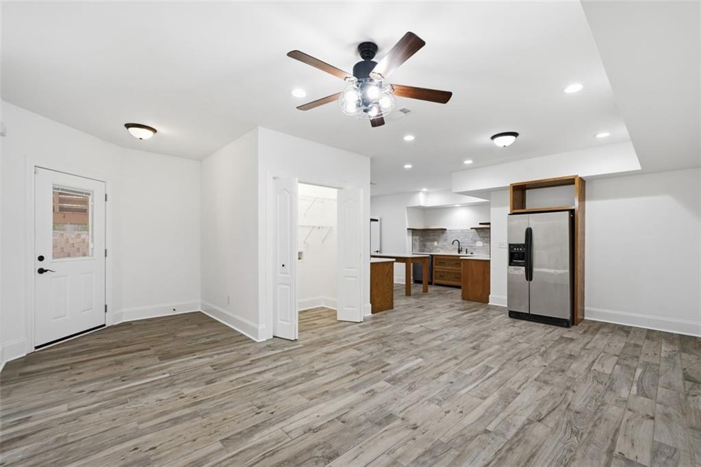 7611 Regency Circle Sandy Springs, GA 30350 - Photo 65 of 74 a view of a kitchen with wooden floor and a ceiling fan