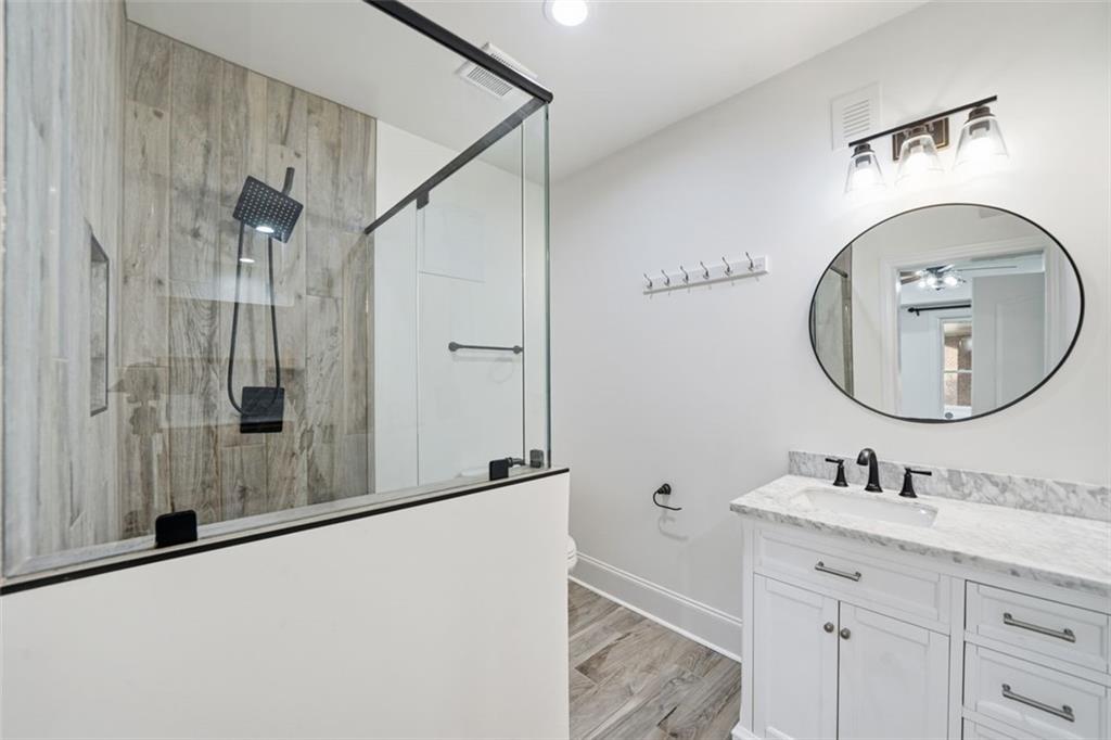7611 Regency Circle Sandy Springs, GA 30350 - Photo 73 of 74 a bathroom with a sink mirror vanity and a shower