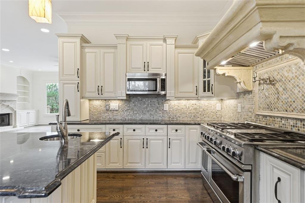 7611 Regency Circle Sandy Springs, GA 30350 - Photo 10 of 74 a kitchen with stainless steel appliances granite countertop a sink a stove and a granite counter tops