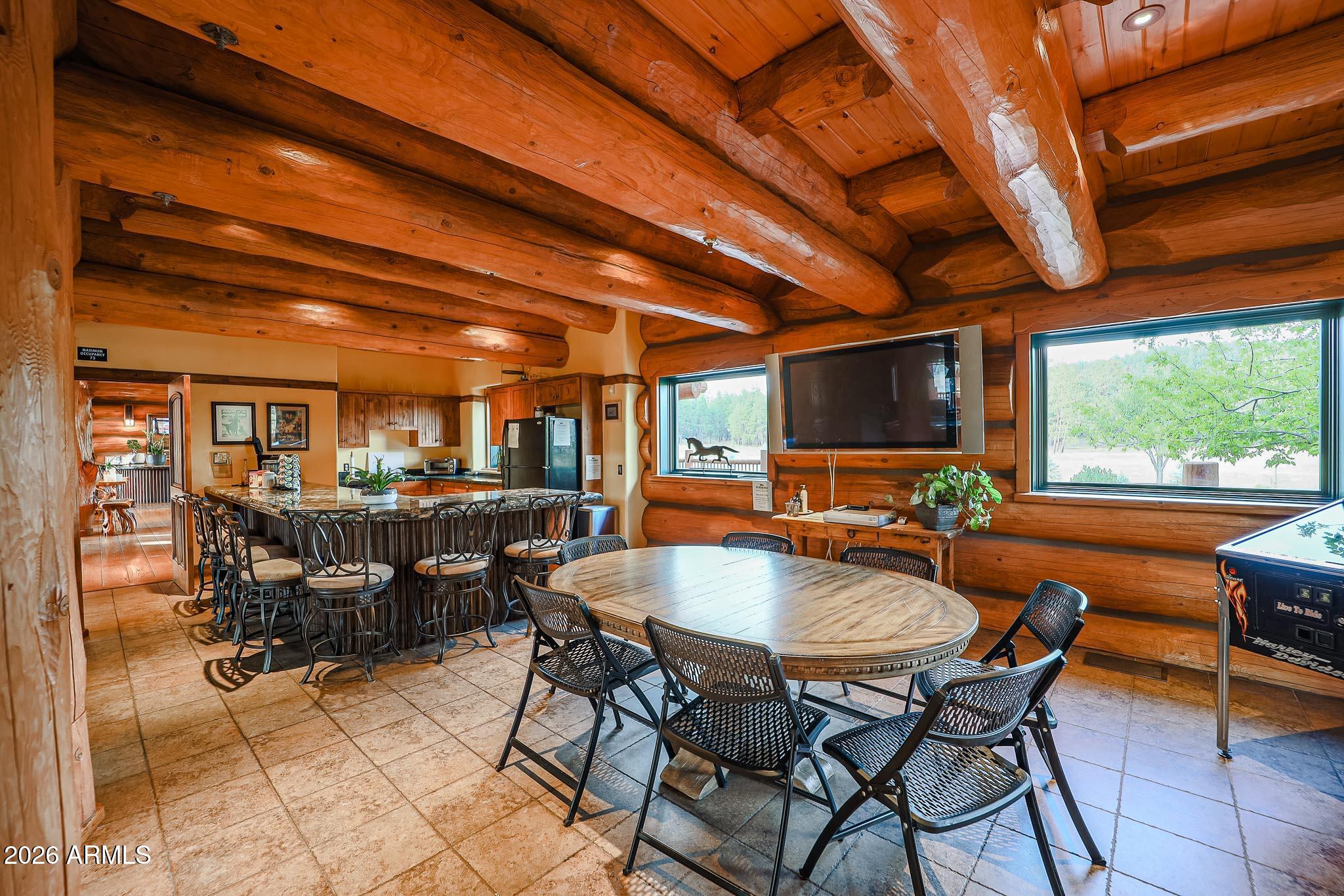 405 East Foxboro Road Munds Park, AZ 86017 - Photo 117 of 131 a dining room with furniture and a floor to ceiling window
