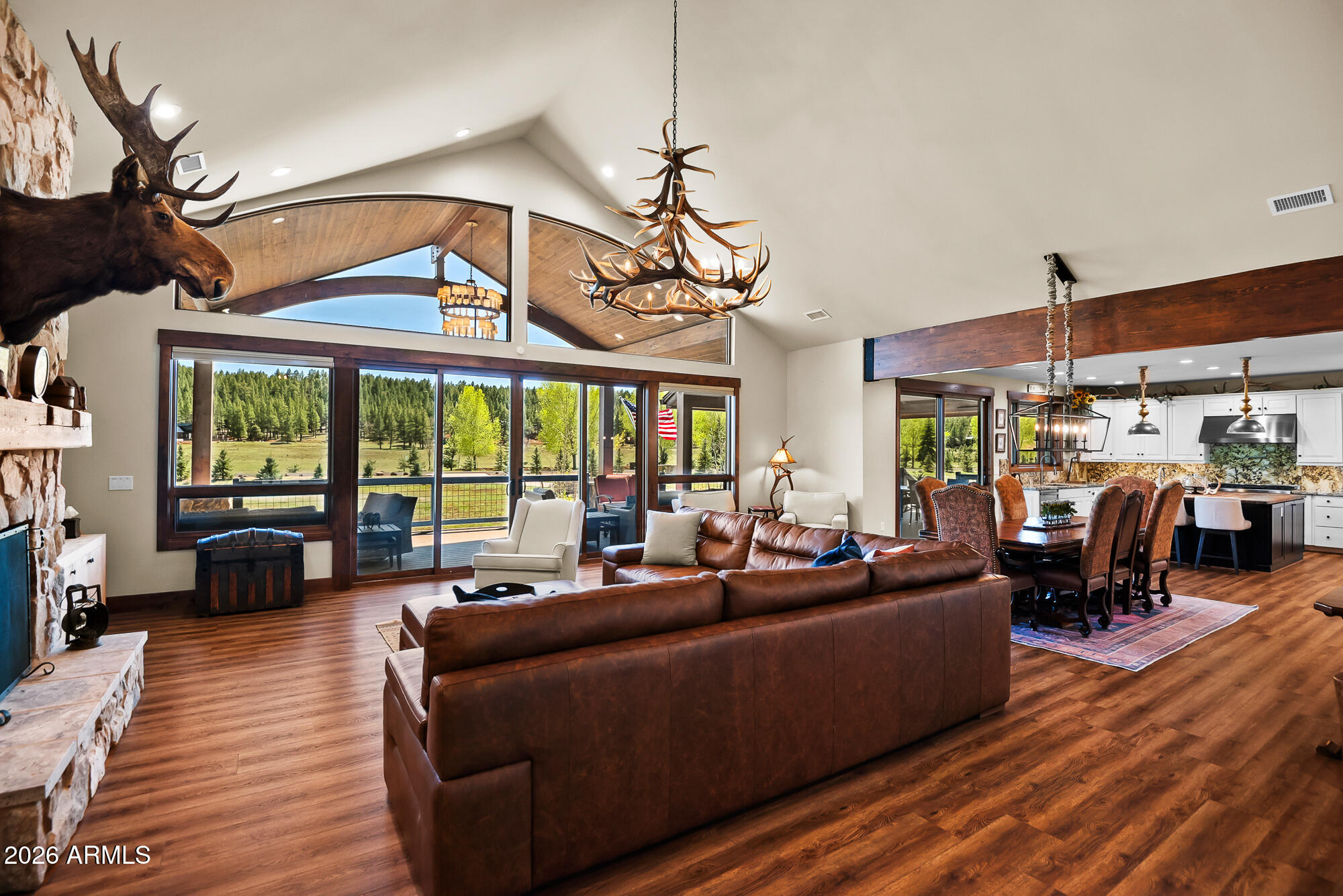 405 East Foxboro Road Munds Park, AZ 86017 - Photo 14 of 131 a living room with furniture a fireplace and a floor to ceiling window