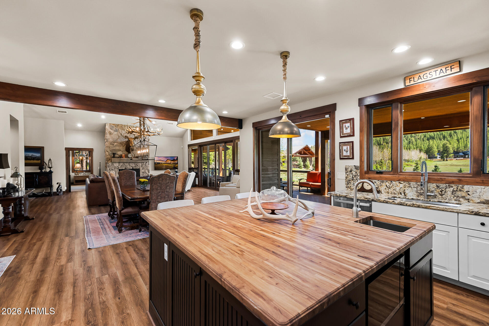 405 East Foxboro Road Munds Park, AZ 86017 - Photo 41 of 131 a view of a dining room and livingroom with furniture wooden floor a chandelier