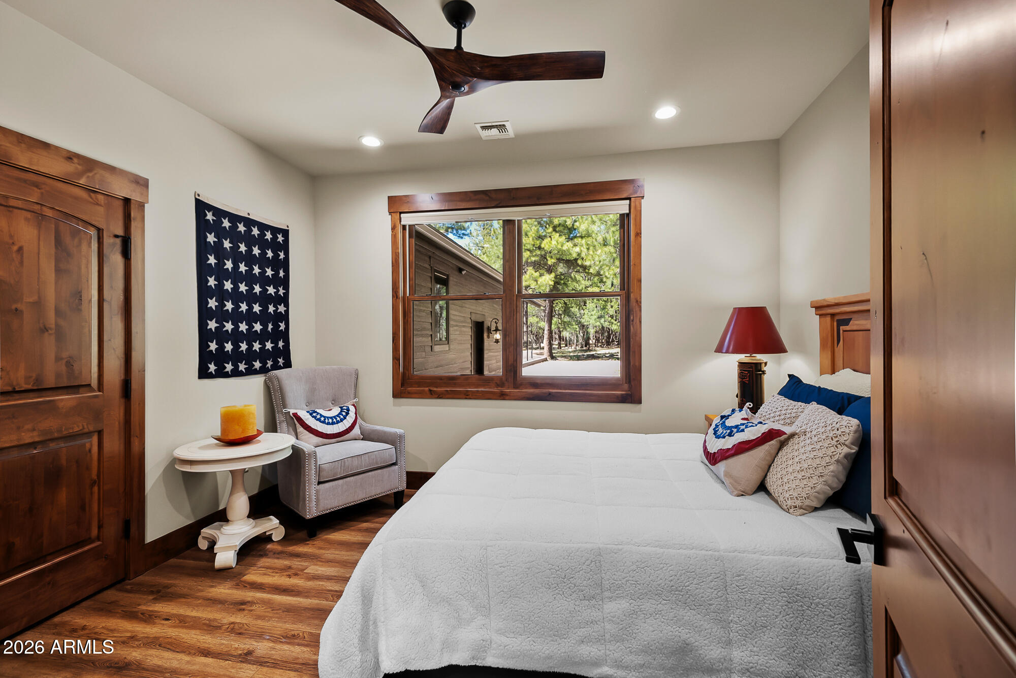 405 East Foxboro Road Munds Park, AZ 86017 - Photo 44 of 131 a bedroom with a bed and wooden floor