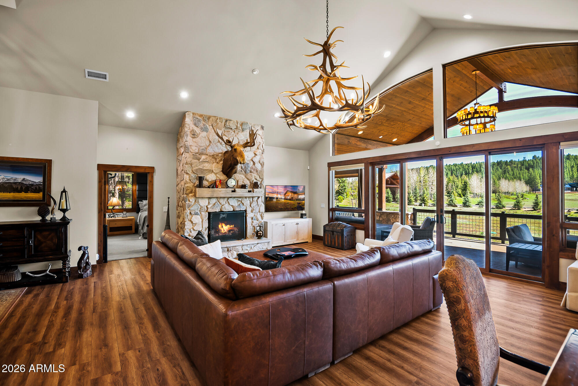 405 East Foxboro Road Munds Park, AZ 86017 - Photo 46 of 131 a living room with fireplace furniture and a chandelier
