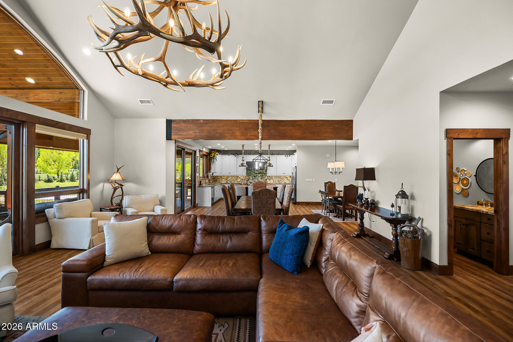 405 East Foxboro Road Munds Park, AZ 86017 - Photo 58 of 131 a living room with furniture a chandelier and a flat screen tv