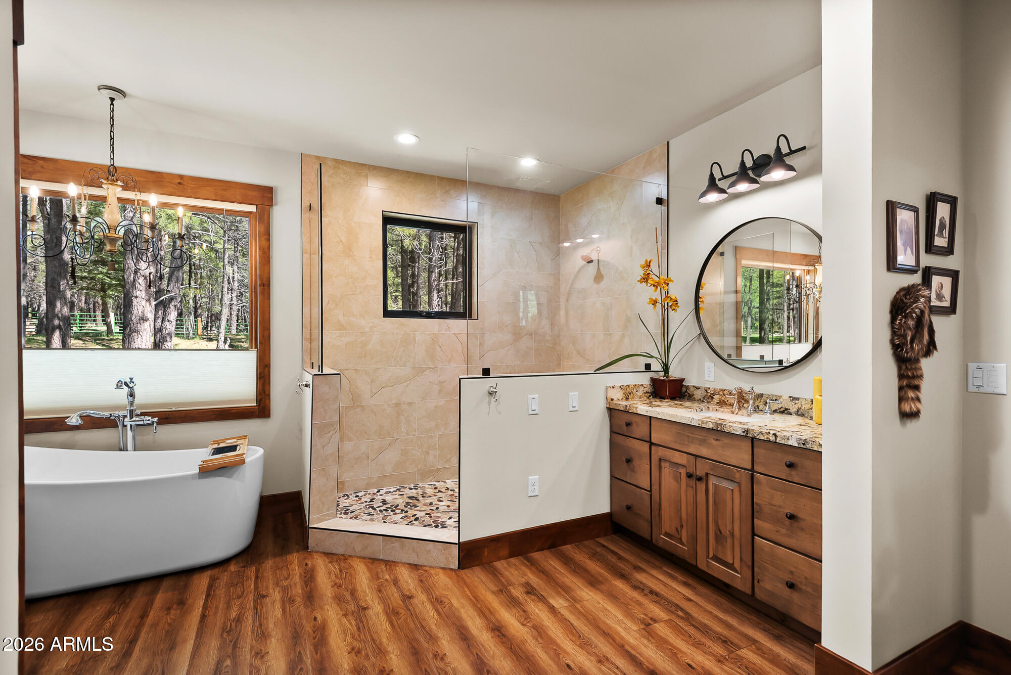 405 East Foxboro Road Munds Park, AZ 86017 - Photo 6 of 131 a spacious bathroom with a granite countertop tub sink and mirror