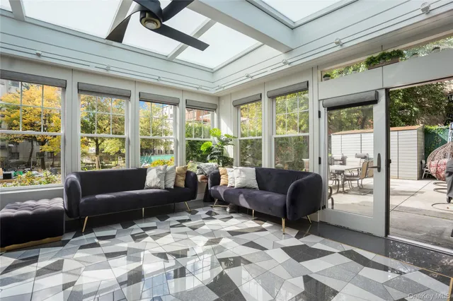 a living room with furniture and large windows