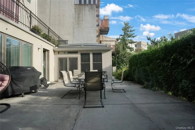 a view of a patio with table and chairs and potted plants