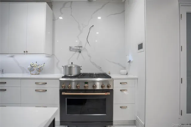 a stove top oven sitting inside of a kitchen