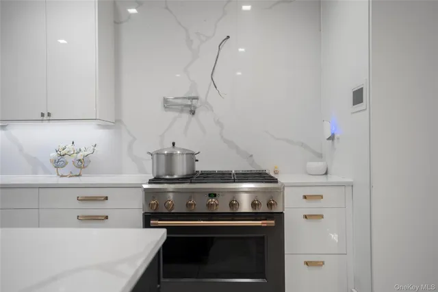 a stove top oven sitting inside of a kitchen