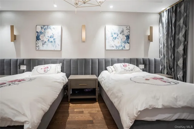 a bedroom with bed and a painting on the wall