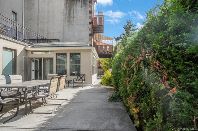 a view of a patio with table and chairs and potted plants