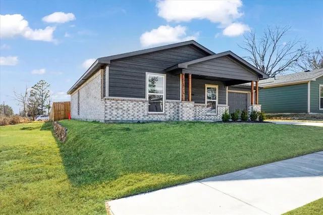 a front view of house with yard and green space