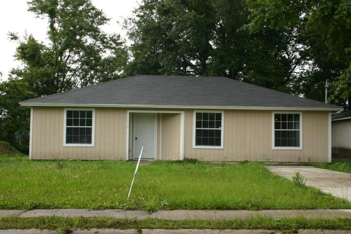 6904 Champlain Road Jacksonville, FL 32208 - Photo 1 of 1 a view of a yard in front of a house with plants and large tree