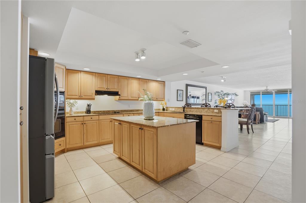 16326 Gulf Boulevard, Unit 307 Redington Beach, FL 33708 - Photo 5 of 43 a kitchen with cabinets and chairs