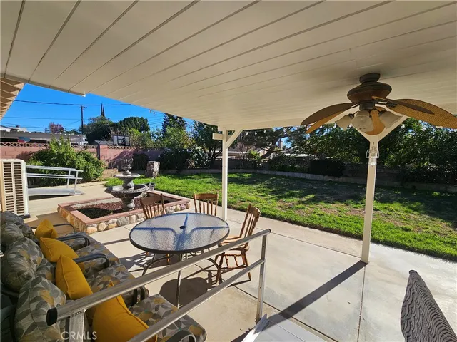 a view of a patio with a table chairs and a swimming pool